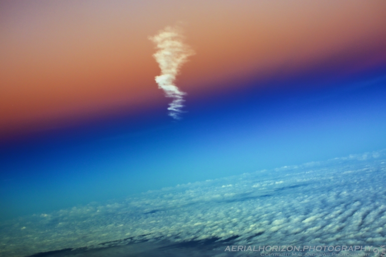 Contrail floating into daylight